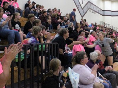 Handing out pink carnations to survivors or those battling ANY form of cancer from either school.