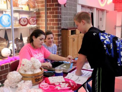 National Honor Society volunteers obtain service hours while helping out at our basket table.